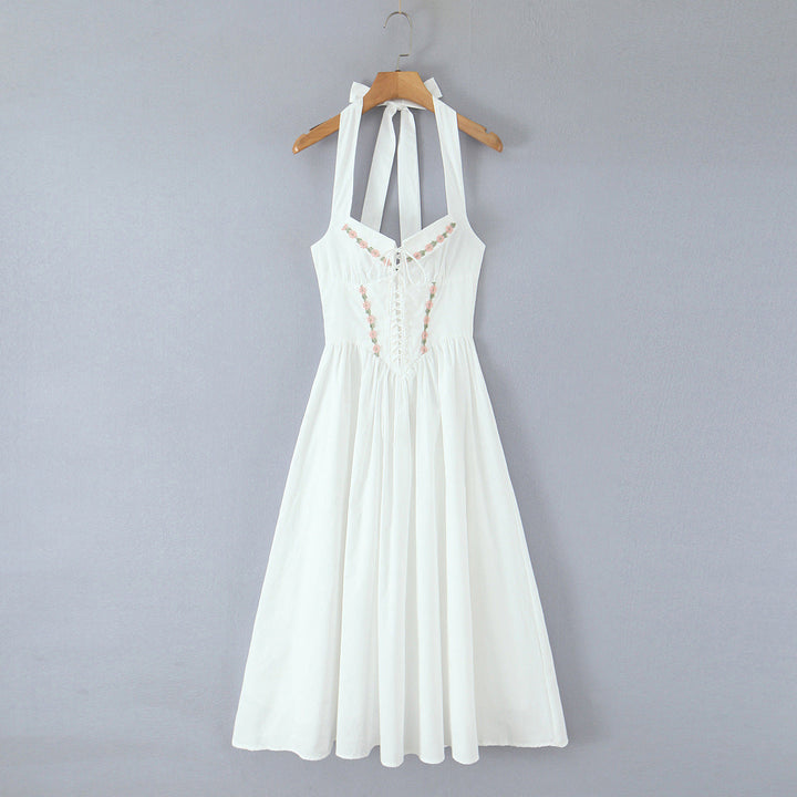Jenia midi dress with a neck tie, open back, and floral embroidery
