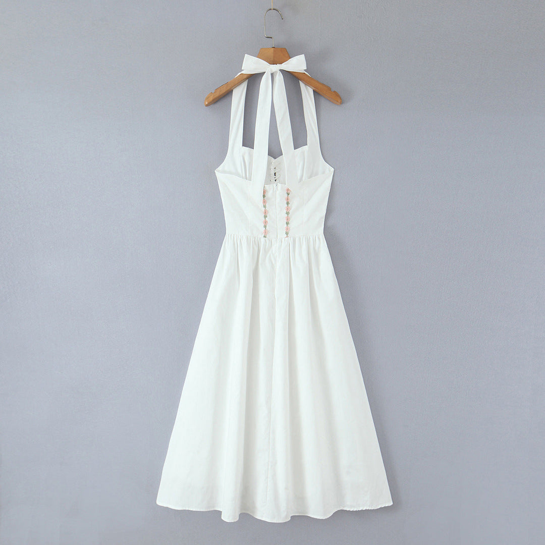Jenia midi dress with a neck tie, open back, and floral embroidery