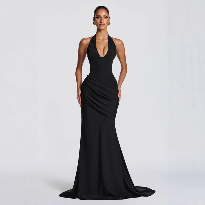Erin maxi dress with an open back, a back tie for a fitted waist, and a pleated design