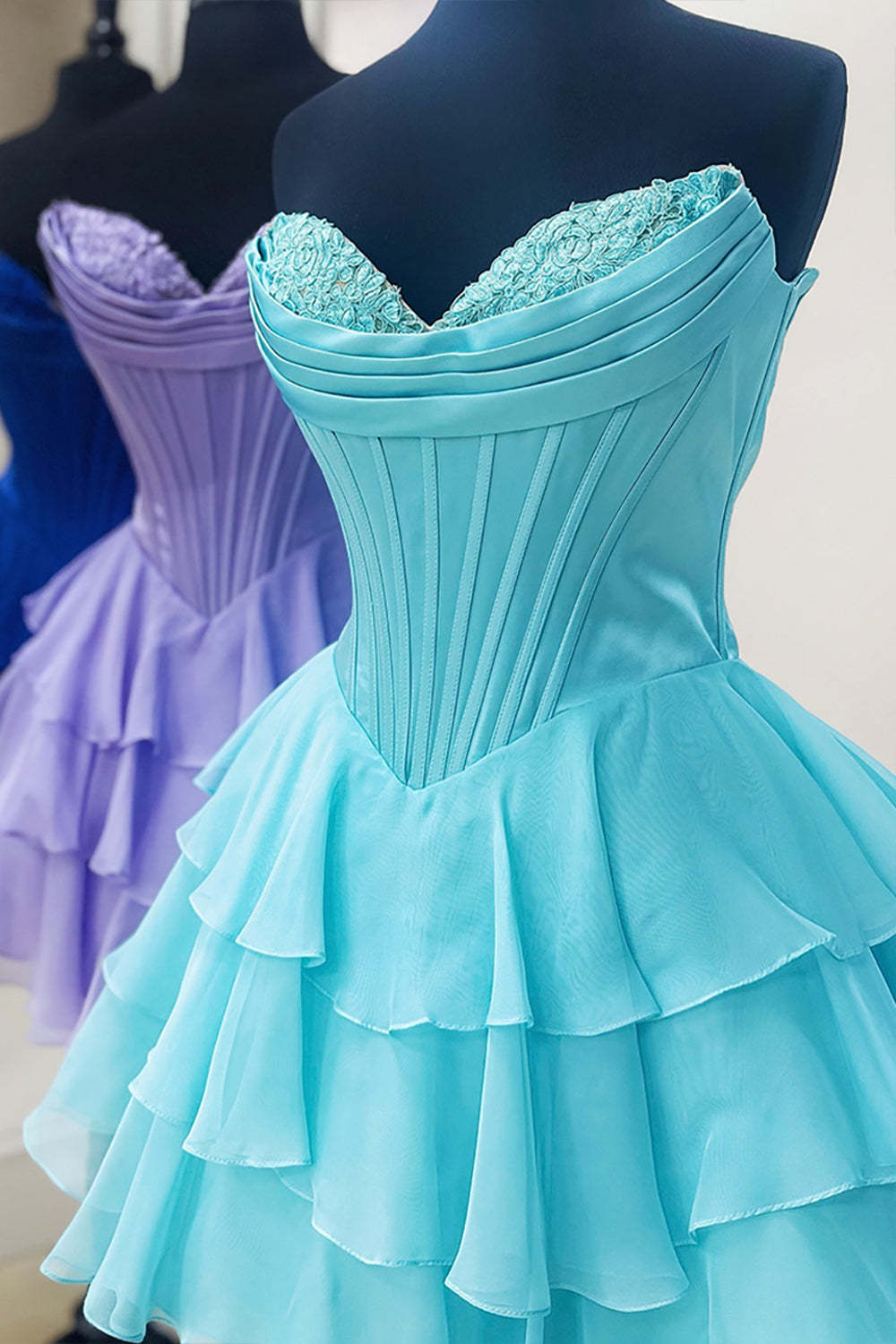 SHERY strapless mini dress with tiered ruffles, corset design, back tie, and waist-cinching fit