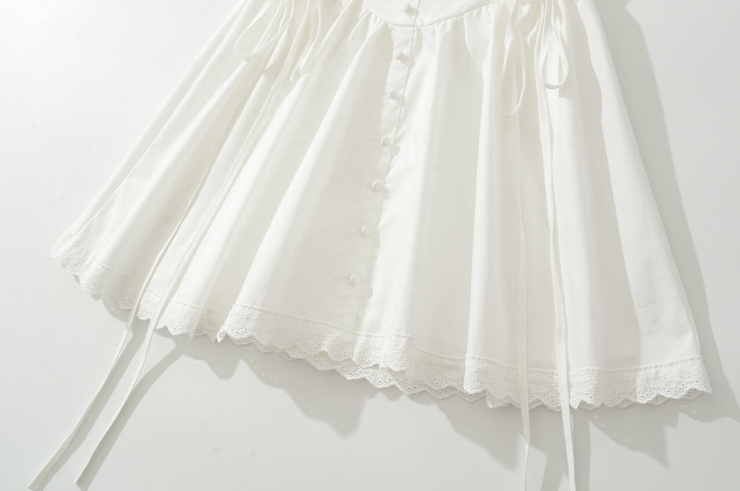 A-line mini dress with tie and button embellishments – Vanessa
