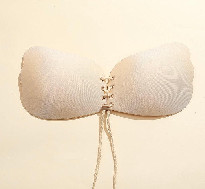 Adhesive strapless bra for securing the breasts