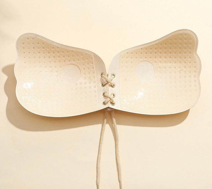 Adhesive strapless bra for securing the breasts