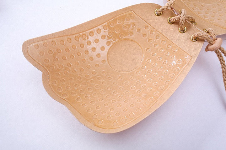 Adhesive strapless bra for securing the breasts