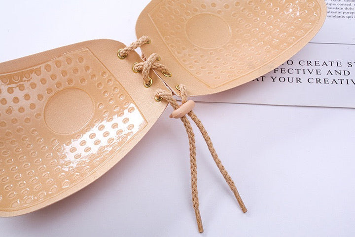 Adhesive strapless bra for securing the breasts