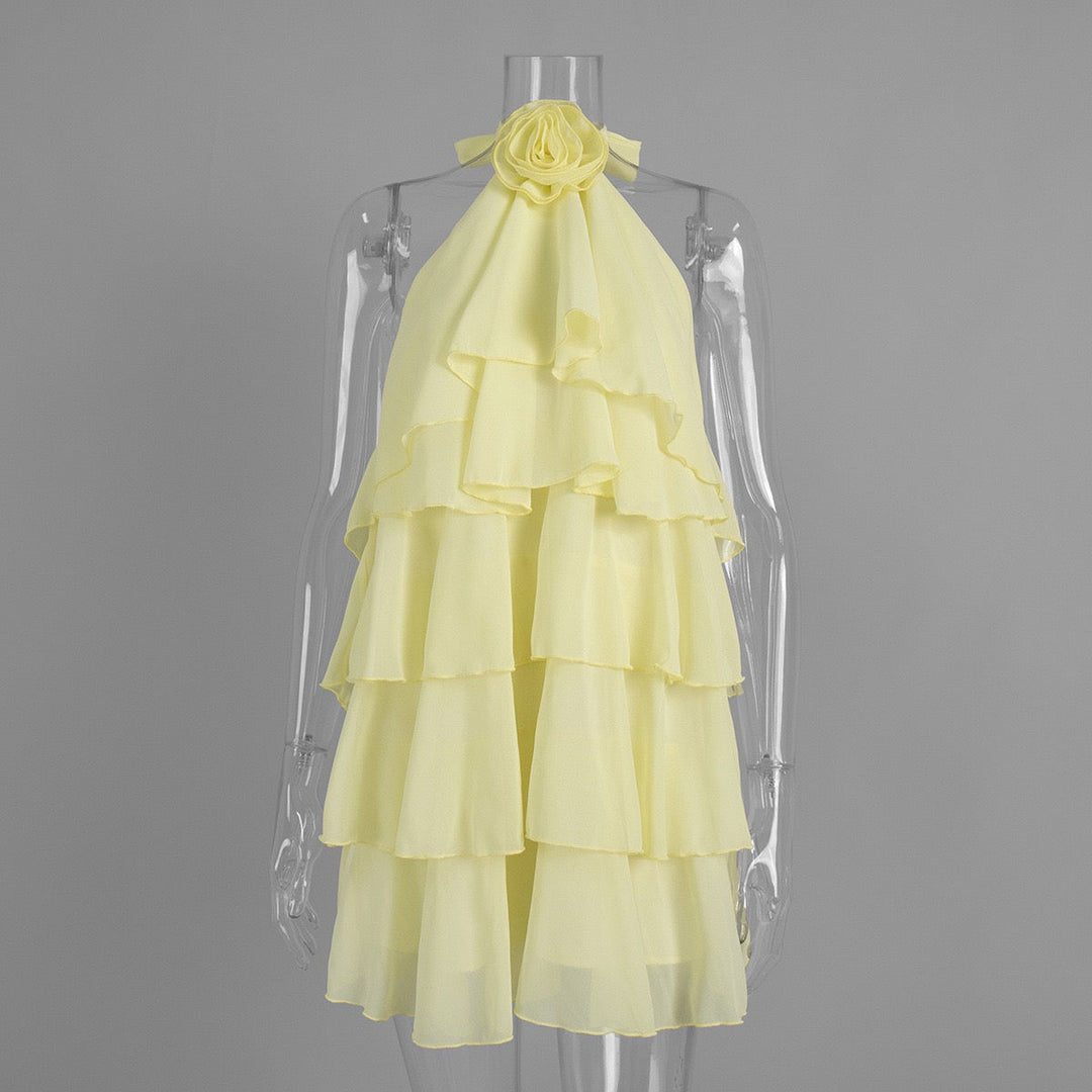 Lily tiered chiffon ruffle mini dress with a neck tie, open back, and floral trim