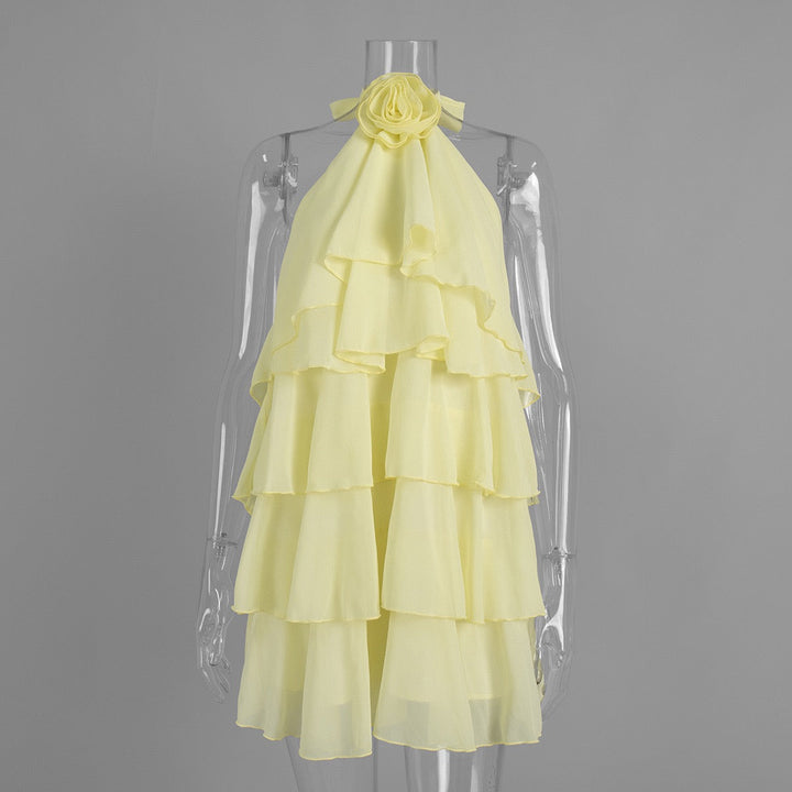 Lily tiered chiffon ruffle mini dress with a neck tie, open back, and floral trim