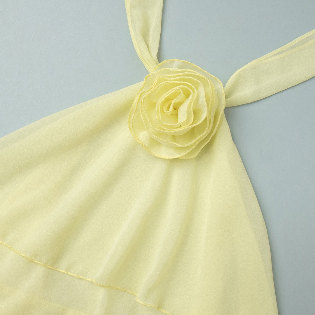 Lily tiered chiffon ruffle mini dress with a neck tie, open back, and floral trim