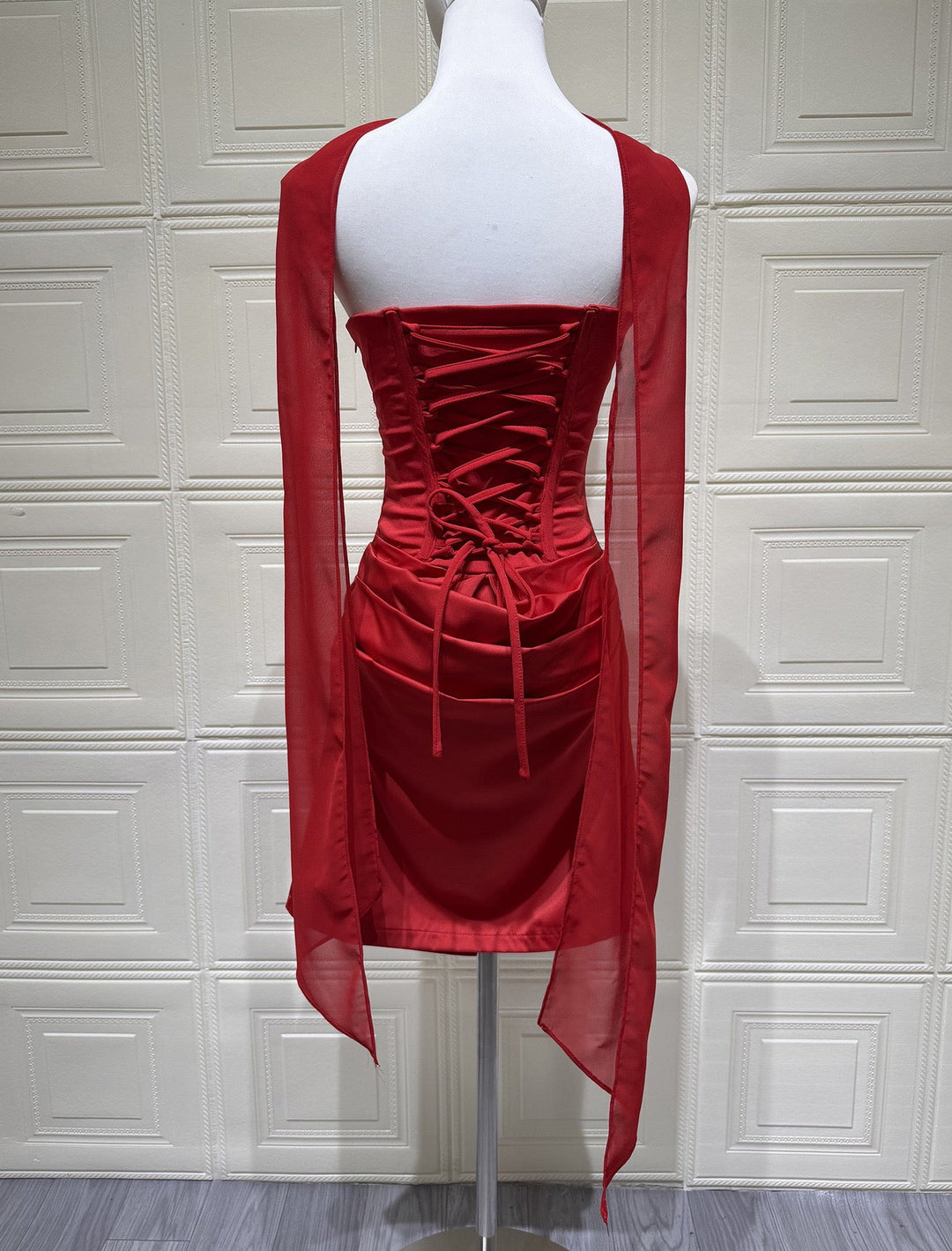 GENNA strapless satin mini dress with pleats, a tie-up corset at the back for a fitted waist, and a scarf detail