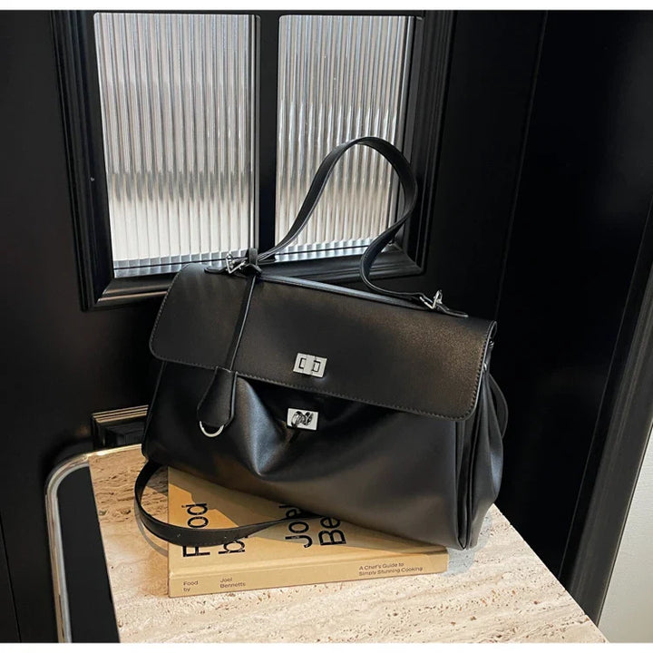 Leather bag with buckle closure