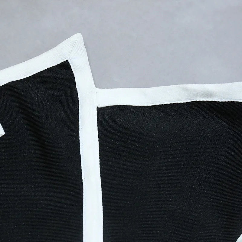 One-piece strapless swimsuit in a luxurious asymmetrical design with bow tie decoration combined with a matching skirt in monochrome colors - Gabriella