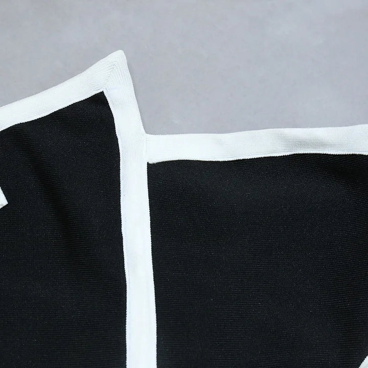 One-piece strapless swimsuit in a luxurious asymmetrical design with bow tie decoration combined with a matching skirt in monochrome colors - Gabriella