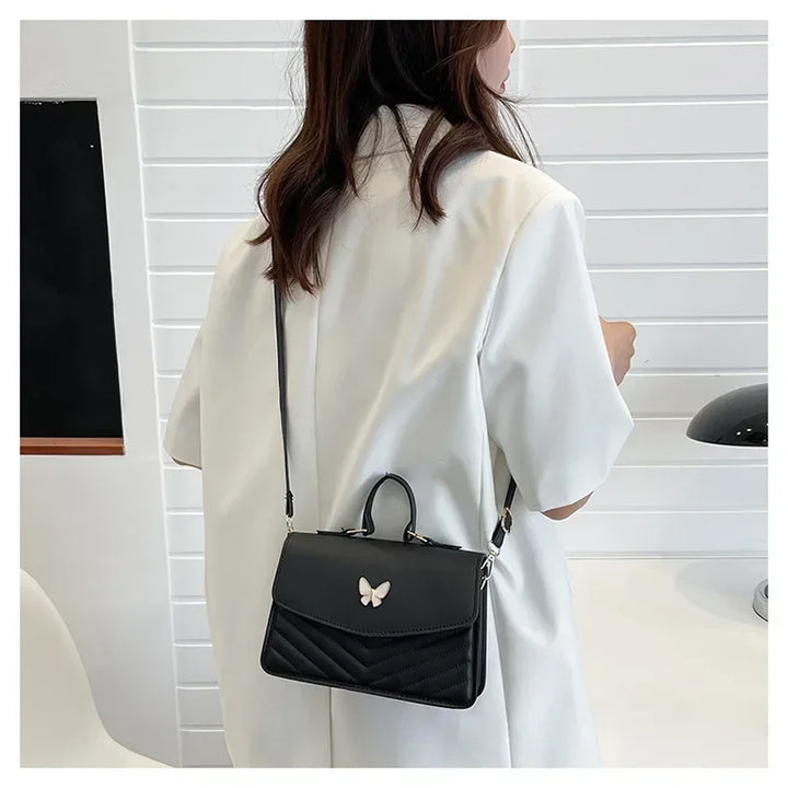 Faux leather bag with butterfly decoration