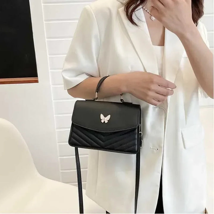Faux leather bag with butterfly decoration