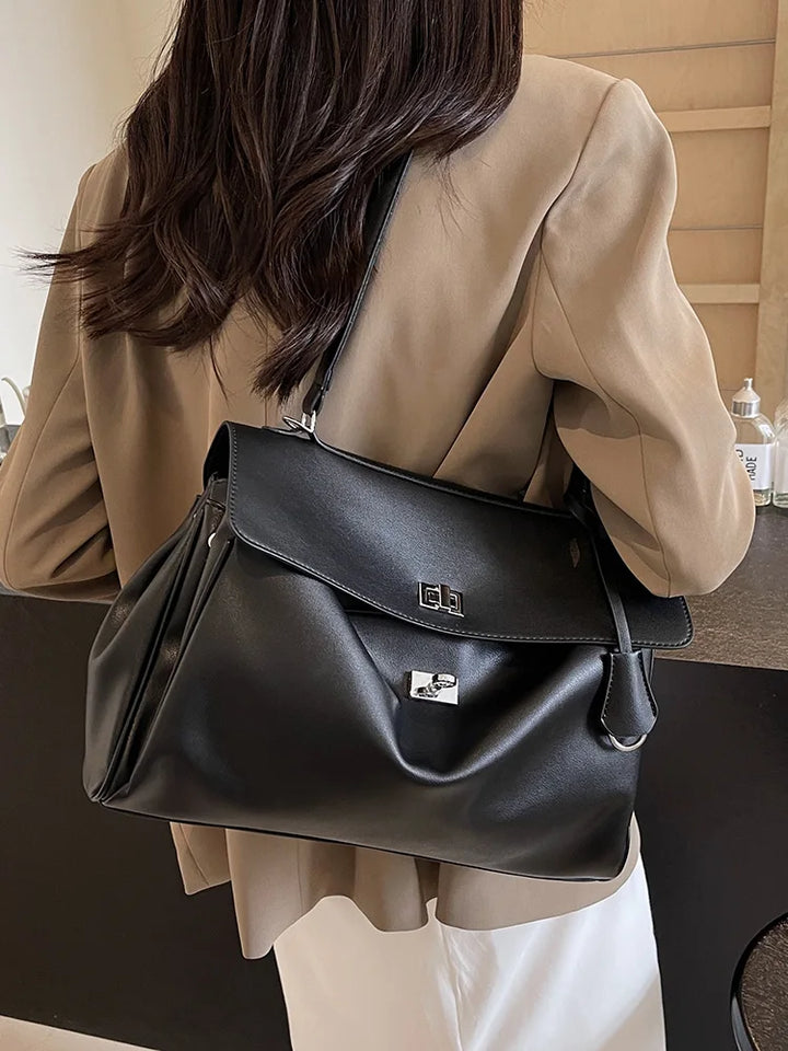 Leather bag with buckle closure