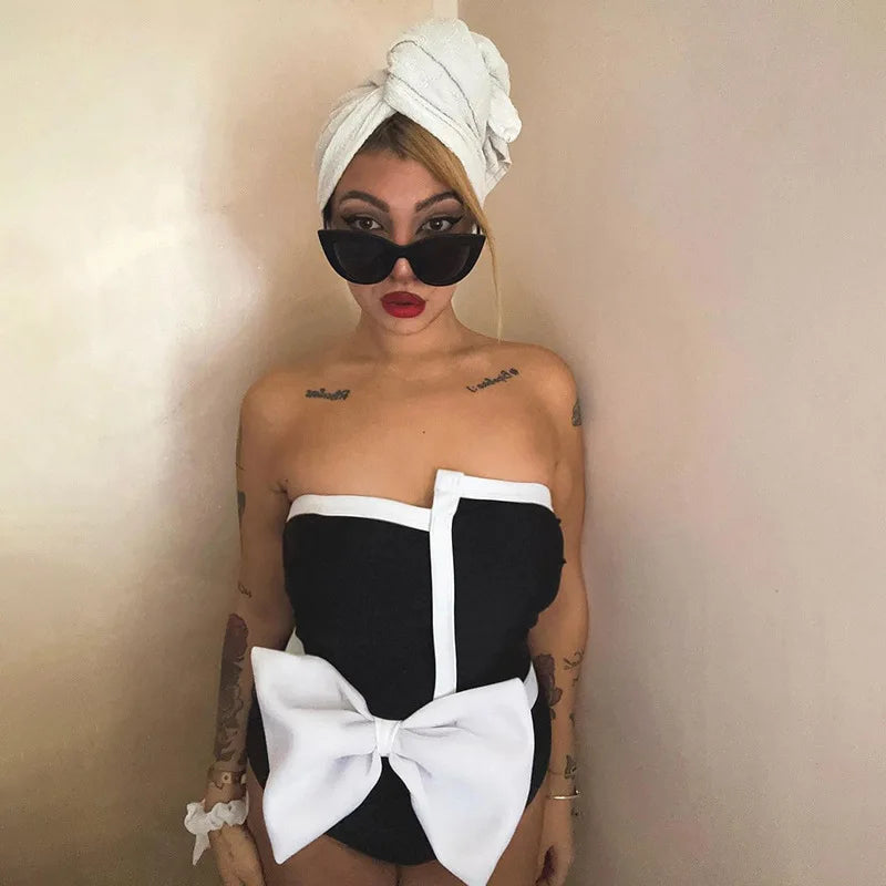 One-piece strapless swimsuit in a luxurious asymmetrical design with bow tie decoration combined with a matching skirt in monochrome colors - Gabriella