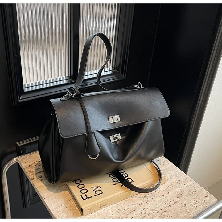 Leather bag with buckle closure