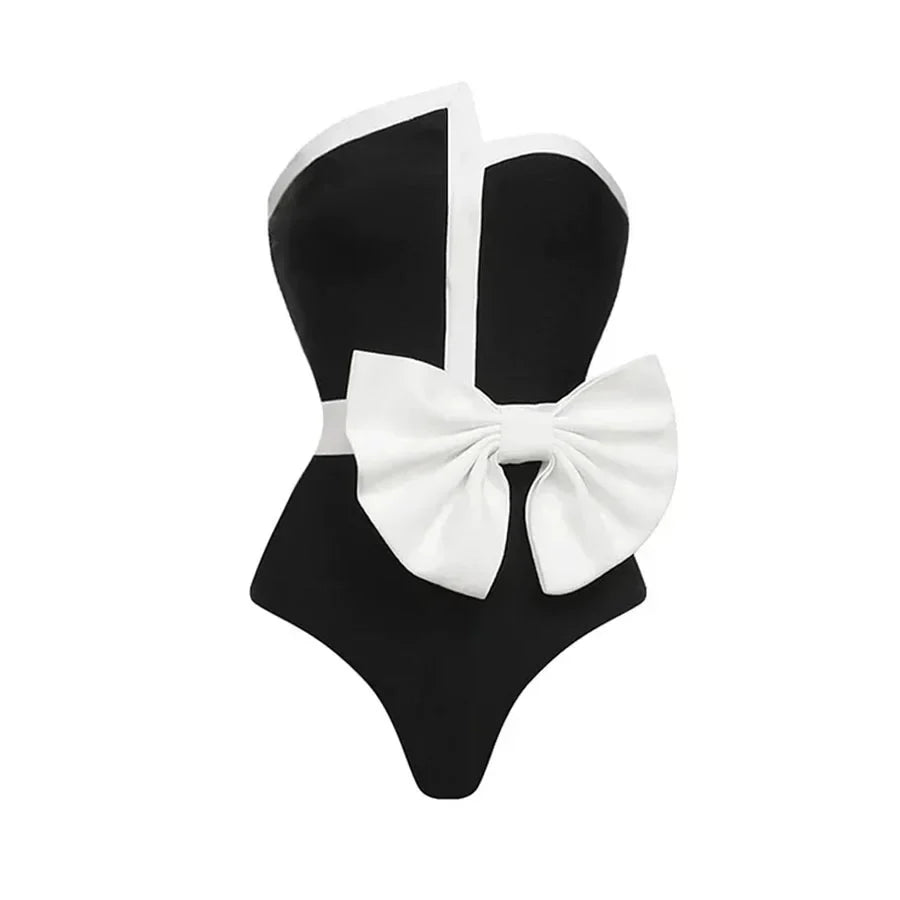 One-piece strapless swimsuit in a luxurious asymmetrical design with bow tie decoration combined with a matching skirt in monochrome colors - Gabriella