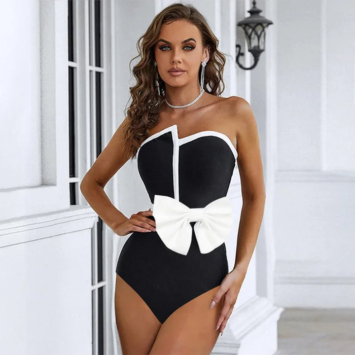 One-piece strapless swimsuit in a luxurious asymmetrical design with bow tie decoration combined with a matching skirt in monochrome colors - Gabriella