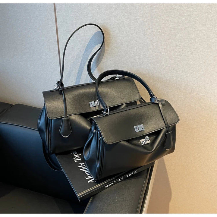 Leather bag with buckle closure