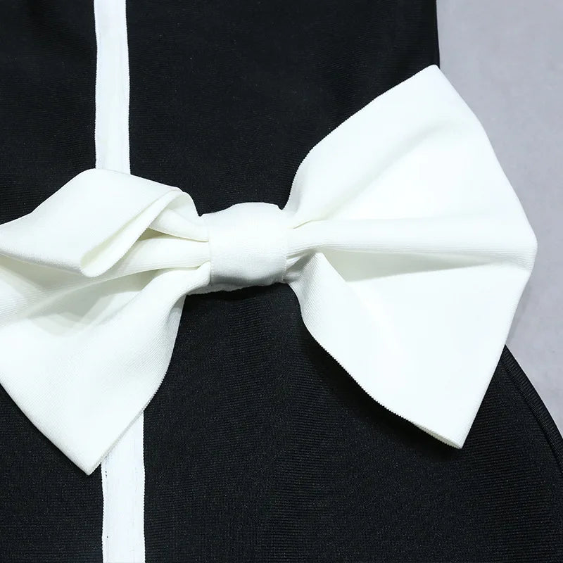 One-piece strapless swimsuit in a luxurious asymmetrical design with bow tie decoration combined with a matching skirt in monochrome colors - Gabriella
