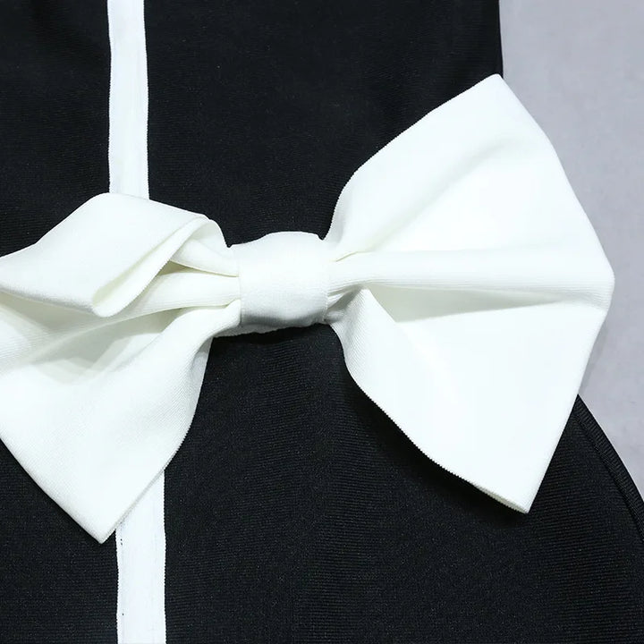 One-piece strapless swimsuit in a luxurious asymmetrical design with bow tie decoration combined with a matching skirt in monochrome colors - Gabriella
