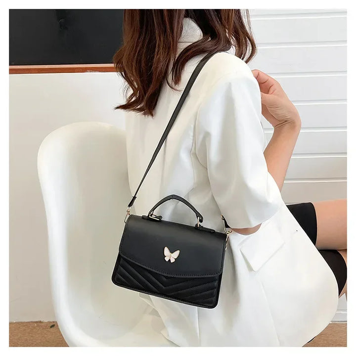 Faux leather bag with butterfly decoration