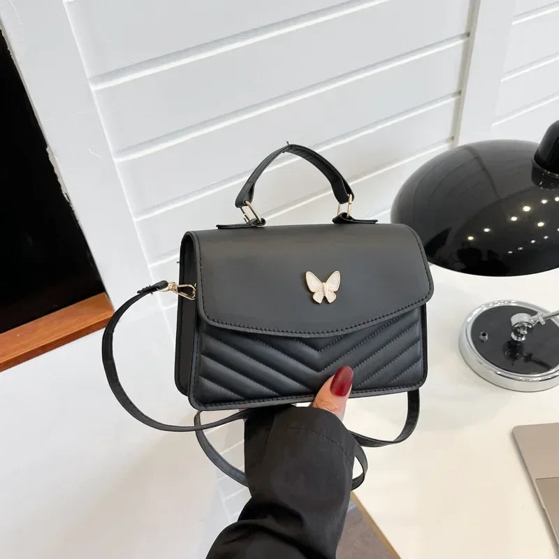 Faux leather bag with butterfly decoration