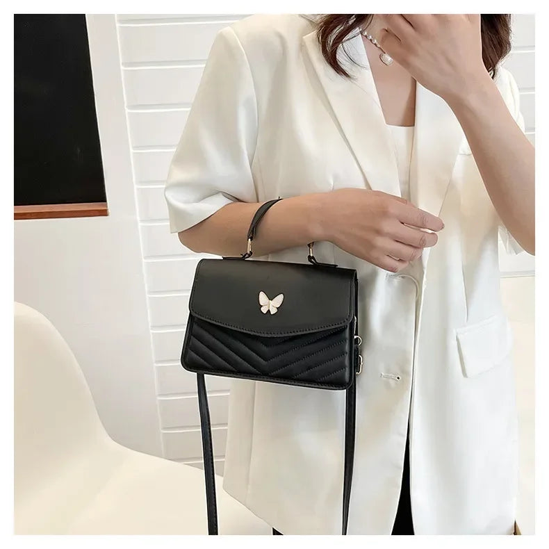 Faux leather bag with butterfly decoration