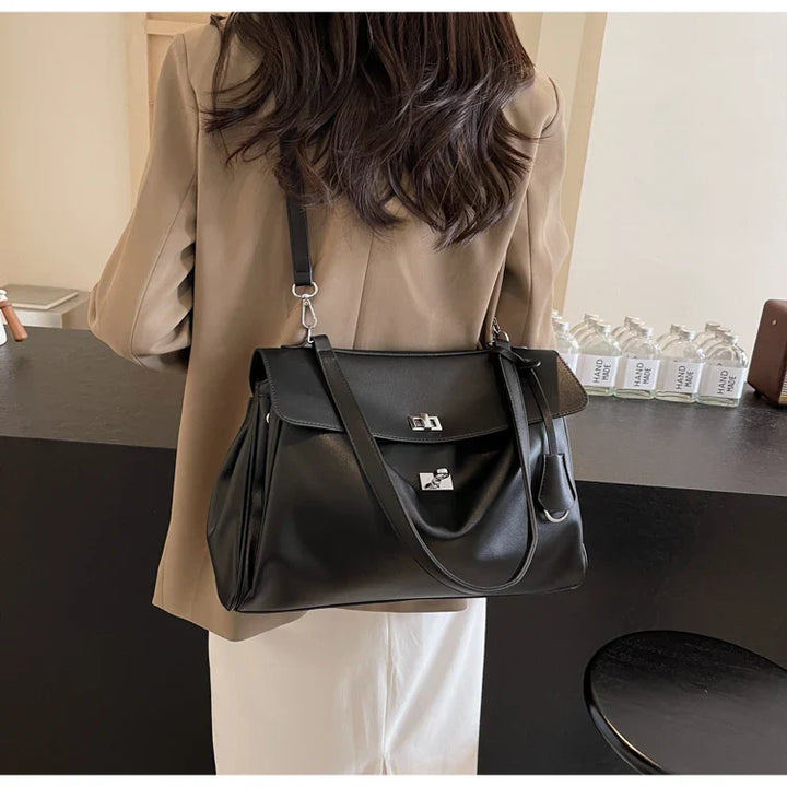 Leather bag with buckle closure