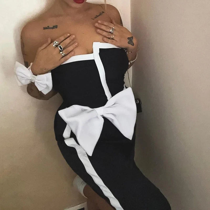 One-piece strapless swimsuit in a luxurious asymmetrical design with bow tie decoration combined with a matching skirt in monochrome colors - Gabriella