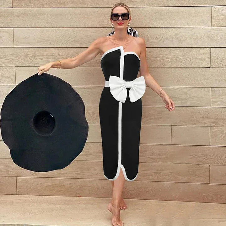 One-piece strapless swimsuit in a luxurious asymmetrical design with bow tie decoration combined with a matching skirt in monochrome colors - Gabriella