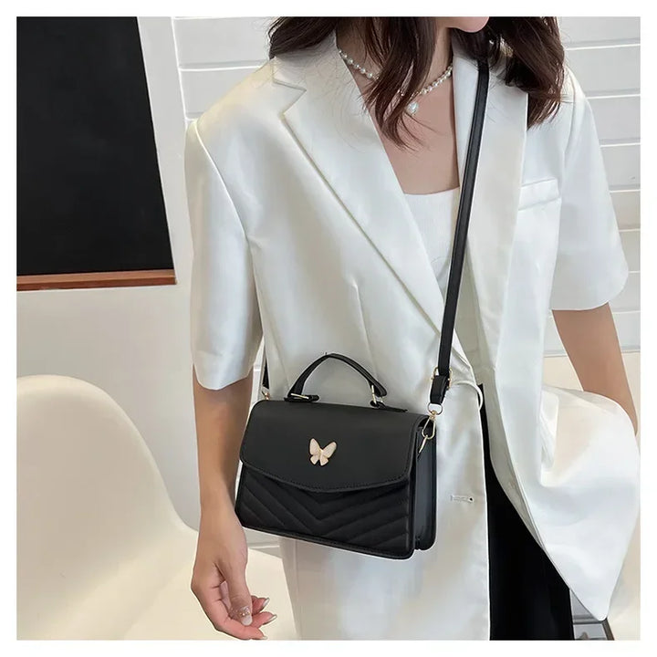 Faux leather bag with butterfly decoration